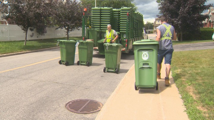 Workers distribute new compost bins in Pointe-Claire on Wednesday, July 22, 2015.
