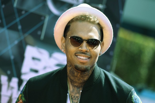 In this June 28, 2015 file photo, Chris Brown arrives at the BET Awards at the Microsoft Theater in Los Angeles. Grammy award-winning singer Brown’s departure from Manila has been delayed because of a fraud complaint against him and his promoter for a canceled concert last New Year’s eve.