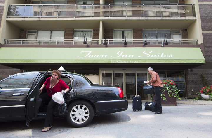Toronto hotels were prepared for an onslaught of July bookings during the Pan Am games, but some may end up checking in even fewer guests than last July. People arrive at the Town Inn Suites hotel in Toronto, Friday July 3, 2015.