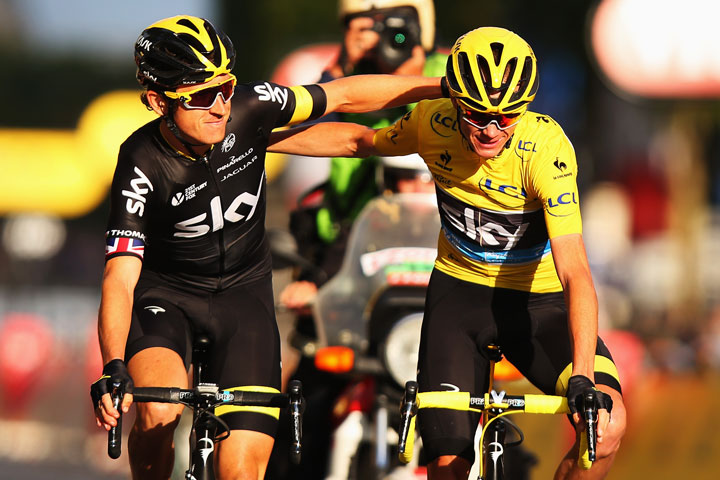 Chris Froome (R) of Great Britain and Team Sky celebrates overall victory with team mate Geraint Thomas (L) of Great Britain and Team Sky following the twenty first stage of the 2015 Tour de France.