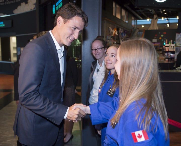 Federal Liberal leader Justin Trudeau greets staff during a visit to the Cosmodome Tuesday, July 21, 2015 in Laval, Que.