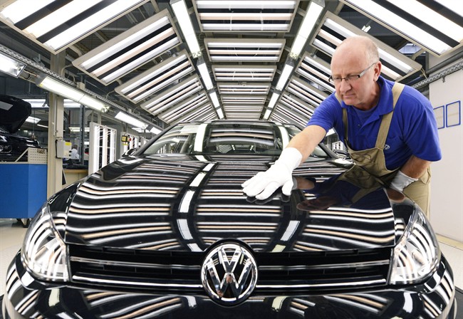 FILE - In this Nov. 9, 2012 file photo worker Michael Keil checks a Golf VII car during a press tour at the plant of the German car manufacturer Volkswagen AG (VW) in Zwickau, central Germany. Volkswagen AG says Wednesday, July 29, 2015, that profits slipped by 16 percent in the second quarter. (AP Photo/Jens Meyer,File)