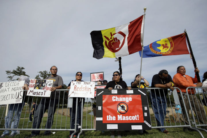 Protestors gather outside of AT&T stadium voicing their stand against the Washington Redskins logo and name before an NFL football game between the Redskins and the Dallas Cowboys, Monday, Oct. 27, 2014. (File photo).