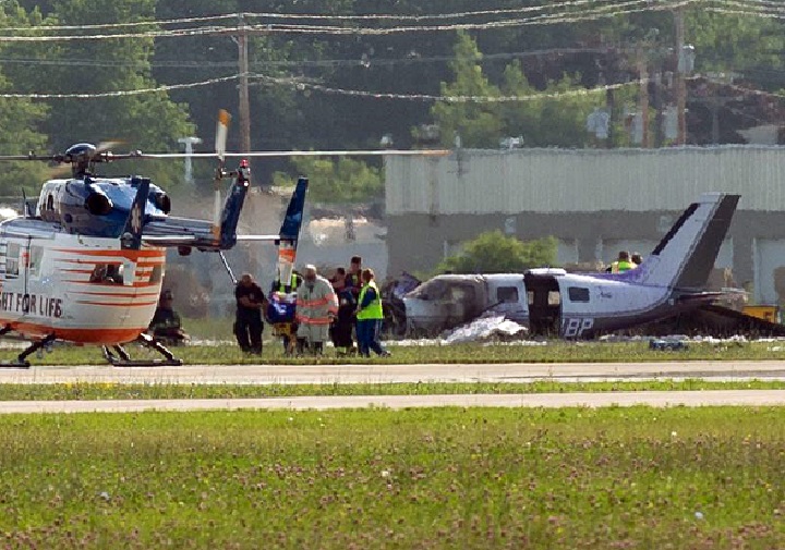 Emergency personnel at the scene of a small plane crash Wednesday, July 22, 2015 at the Experimental Aircraft Association convention in Oshkosh, Wis.