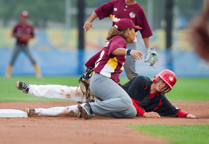 Canada's Nicole Luchanski is called out trying to steal second base as Venezuela's Sor Brito makes the tag during second inning women's baseball action at the Pan American Games in Toronto on Saturday July 25, 2015. 