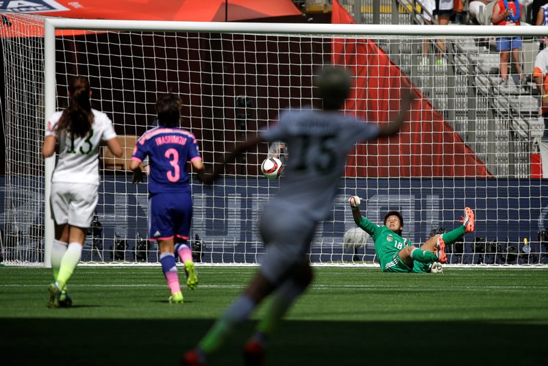 Japan's goalkeeper Ayumi Kaihori, right, goes down after failing to save a goal scored by United States' Carli Lloyd during the first half of the FIFA Women's World Cup soccer championship in Vancouver, British Columbia, Canada, Sunday, July 5, 2015. 