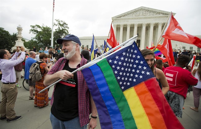 In this June 26, 2015 photo, supporters celebrate outside the U.S. Supreme Court in Washington after the court declared that same-sex couples have a right to marry anywhere in the United States. 