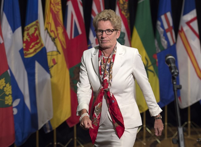 Ontario Premier Kathleen Wynne heads away from the microphone after talking with reporters at the summer meeting of Canada's premiers in St. John's on Thursday, July 16, 2015. 