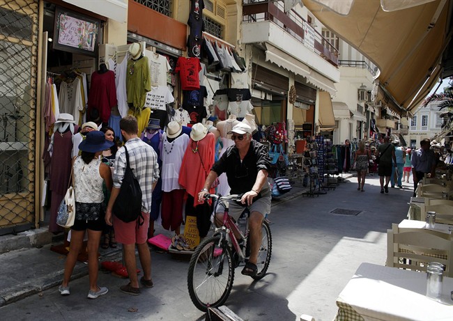A man rides a bicycle at the Plaka tourist district of Athens.