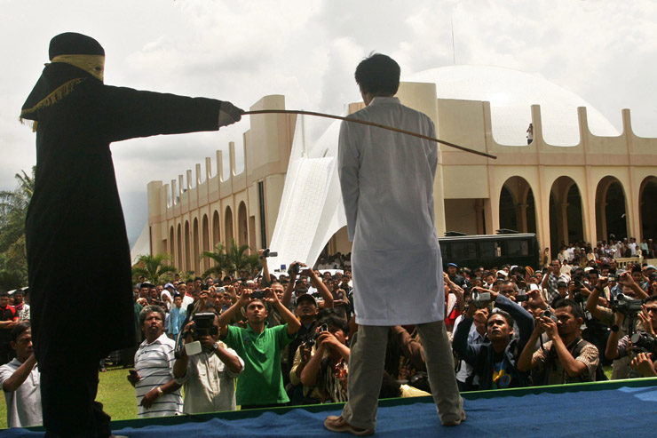 A man is publicly flogged in Indonesia in 2011. 