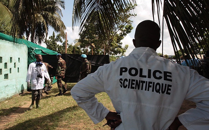 Forensic scientists and doctors prepare for the exhumation of a mass grave site on the grounds of a mosque, in the Yopougon district of Abidjan, Ivory Coast, Thursday, April 4, 2013. Officials exhumed dozens of mass graves dating back to the country's 2011 postelection violence. 