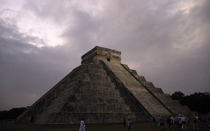 People gather in front of the Kukulkan temple in Chichen Itza, Mexico.  