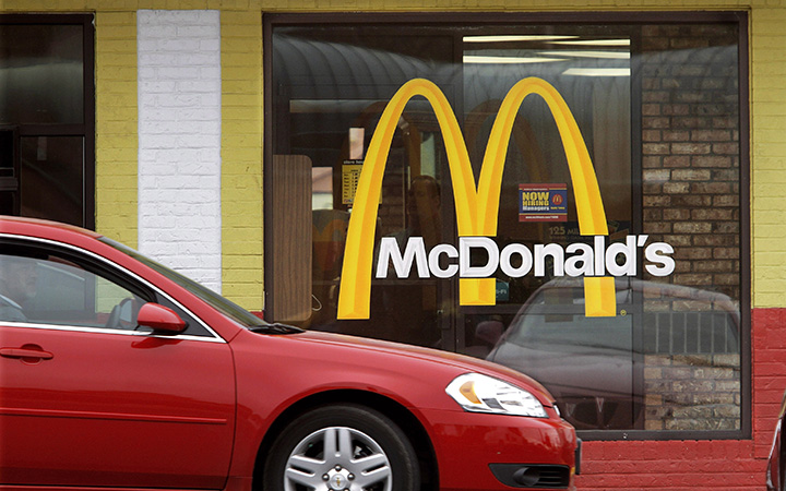 Cars move through the drive-thru window at a McDonald's on  July 29, 2014. 