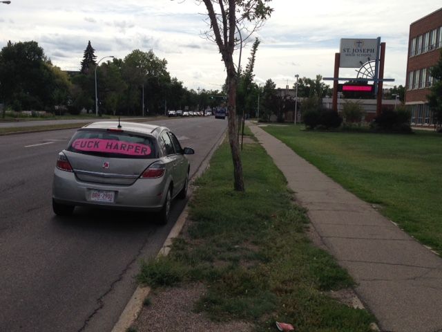 A car with the ‘F–K Harper’ message was parked on 109 Street in Edmonton in front of St. Joseph High School on Thursday.