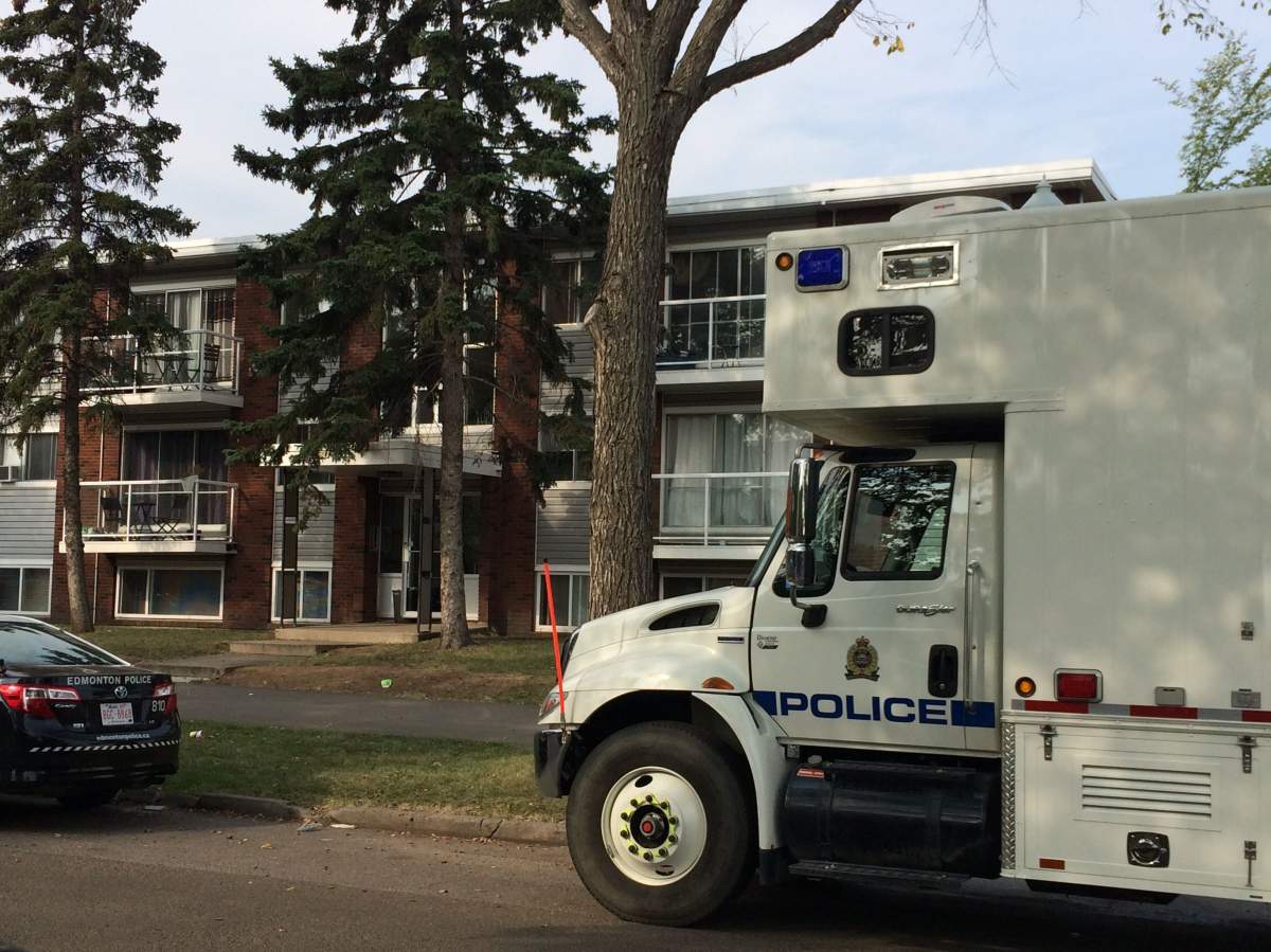 A forensics team is seen outside the apartment where Nadine Skow was found dead. 106 Avenue and 104 Street, August 27, 2015.