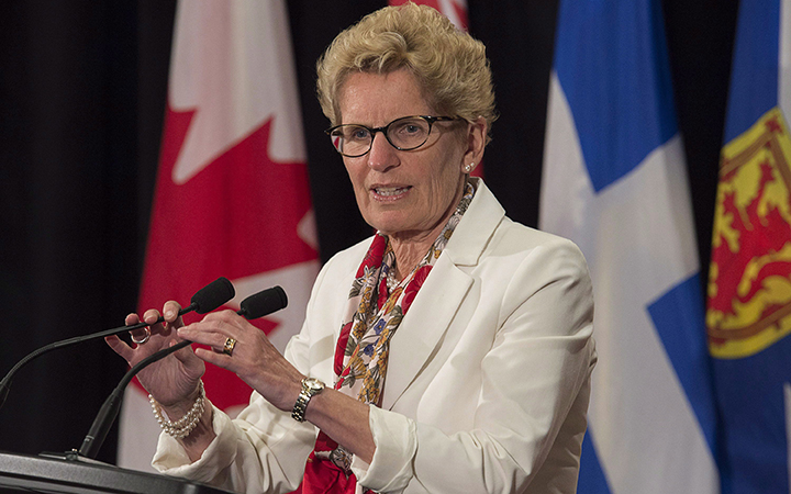 Ontario Premier Kathleen Wynne, pictured July 16, 2015, says her government's auto insurance rate target was a "stretch goal.".
