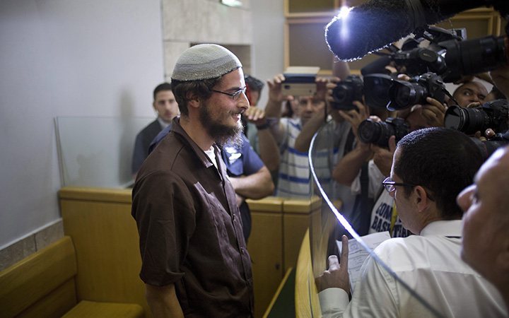 Head of a Jewish extremist group Meir Ettinger appears in court in Nazareth Illit , Israel, Tuesday, Aug. 4, 2015. 