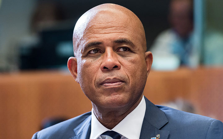 Haiti's President Michel Joseph Martelly waits for the start of a round table meeting at the EU-CELAC summit in Brussels. Hostile comments made by Martelly to a woman at a campaign rally in Haiti have prompted a party in his coalition to remove three officials from his government. 