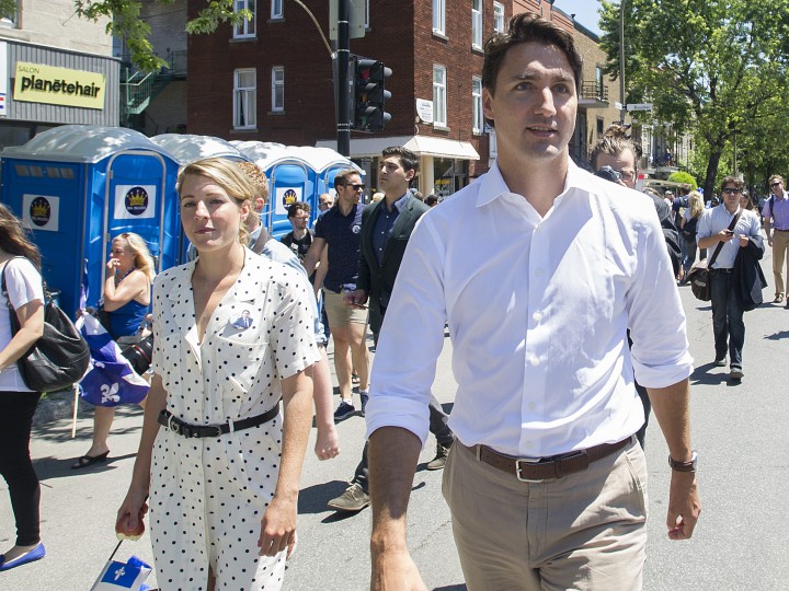 Liberal Party leader Justin Trudeau and Melanie Joly arrive at the annual Saint Jean Baptiste Day parade in Montreal, Wednesday, June 24, 2015.