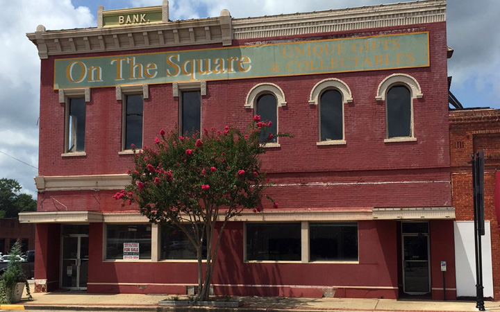 This Aug. 6, 2015, shows the old bank building that once housed the office of author Harper Lee's father A.C. Lee on the courthouse square in Monroeville, Ala. The building is for sale, and local officials hope interest in Lee's newly release "Go Set a Watchman" will spur interest in the historic structure. 