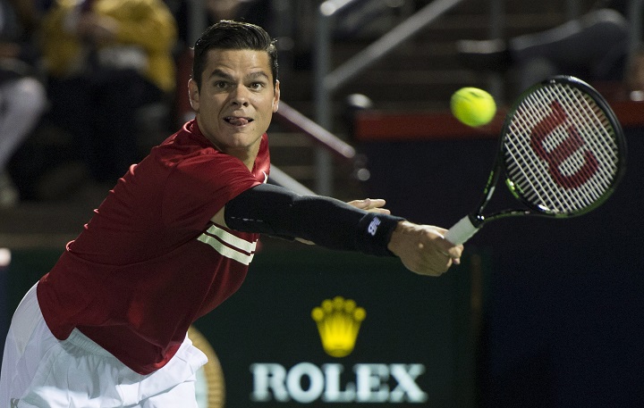 Canada's Milos Raonic returns to Ivo Karlovic from Croatia during second round of play at the Rogers Cup tennis tournament Tuesday August 11, 2015 in Montreal. THE CANADIAN PRESS/Paul Chiasson.