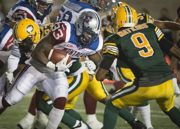 Montreal Alouettes Brandon Rutley runs into Edmonton Eskimos Patrick Watkins during 2nd half CFL action in Montreal on Thursday August 13, 2015.