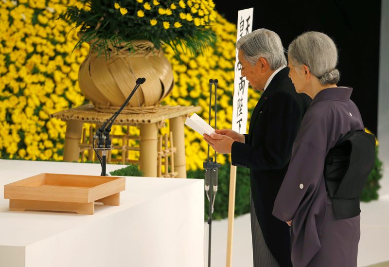 Japan's Emperor Akihito, right, delivers his remarks with Empress Michiko during a memorial service at Nippon Budokan martial arts hall in Tokyo, Saturday, Aug. 15, 2015.