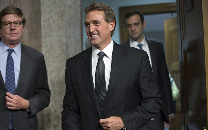 Sen. Jeff Flake, R-Ariz., arrives before Secretary of State John Kerry, Secretary of Energy Ernest Moniz, and Secretary of Treasury Jack Lew, arrive to testify at a Senate Foreign Relations Committee hearing on Capitol Hill, in Washington. 