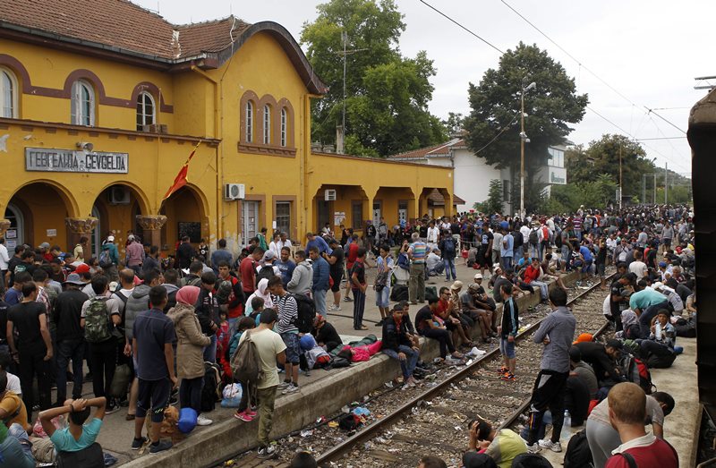 Migrants arrive at the railway station in the southern Macedonia's town of Gevgelija, after breaking through the police blockade on the border with Greece, on Saturday, Aug. 22, 2015.