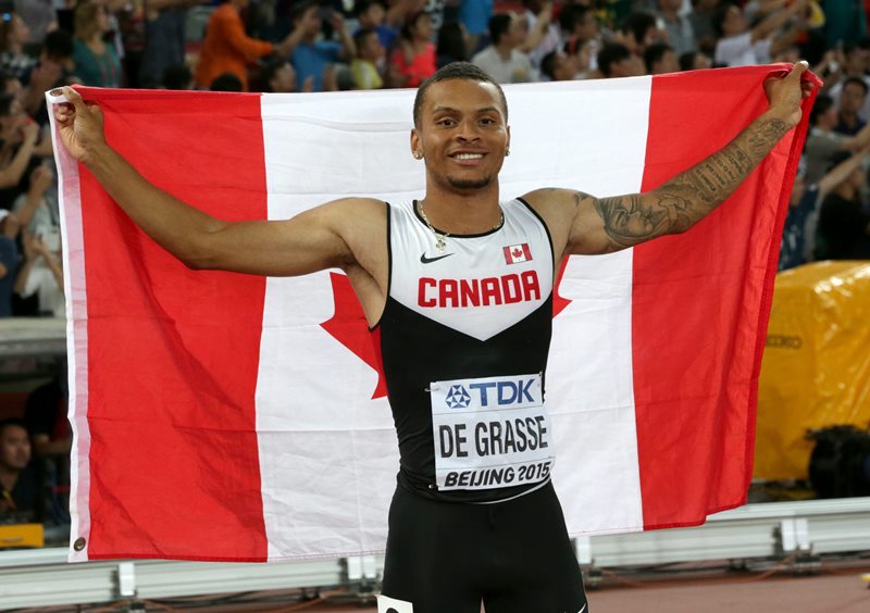 Canada's Andre De Grasse celebrates after winning the bronze medal in the men's 100m at the World Athletics Championships at the Bird's Nest stadium in Beijing, Sunday, Aug. 23, 2015.