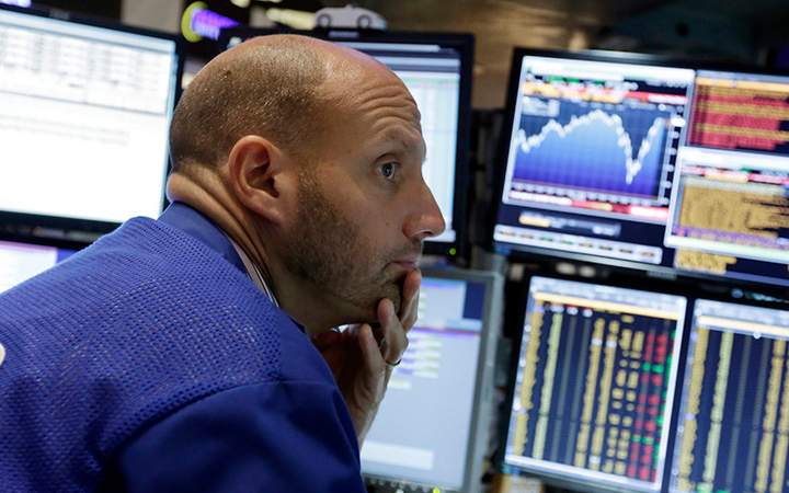 A stock specialist works at his post on the floor of the New York Stock Exchange, Friday, Aug. 28, 2015.