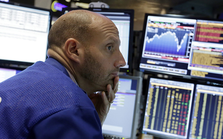 A stock specialist works at his post on the floor of the New York Stock Exchange, Friday, Aug. 28, 2015.