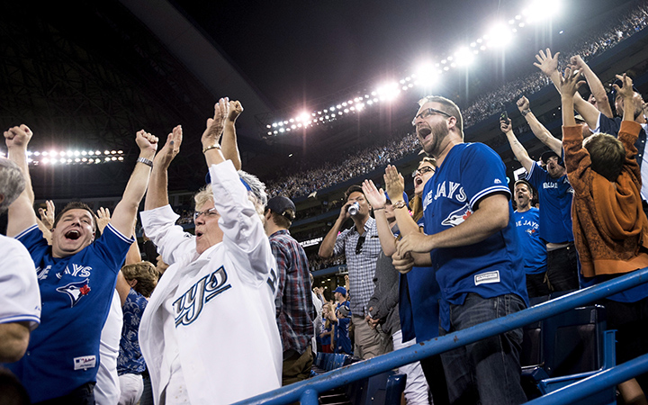 Toronto Blue Jays fas celebrate the Blue Jays' victory over the Detroit Tigers during MLB baseball action in Toronto on Friday, August 28, 2015. 