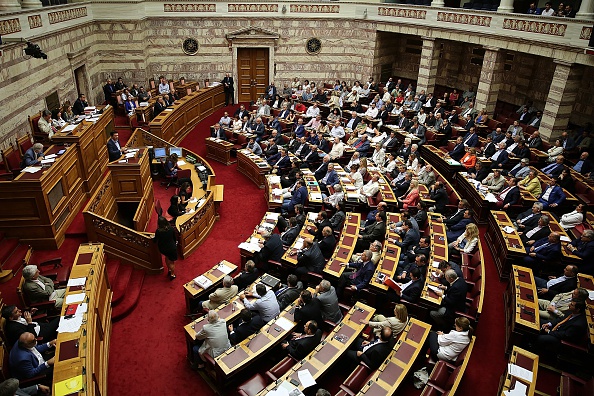 Greek Prime Minister Alexis Tsipras addresses a session at the Greek parliament prior the vote in Athens early on July 23, 2015. (Photo by Ayhan Mehmet/Anadolu Agency/Getty Images).