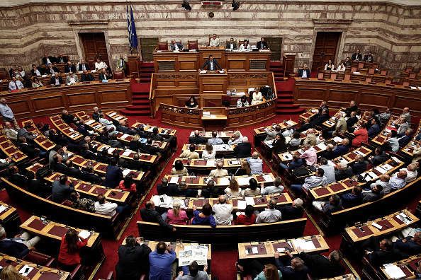 Alexis Tsipras, Greece's prime minister, center, speaks to lawmakers during a vote on a bailout deal in Athens, Greece, on Friday, Aug. 14, 2015. Greece's economy grew in the second quarter in a surprise surge just before the standoff between the government and its creditors forced officials to impose capital controls. 