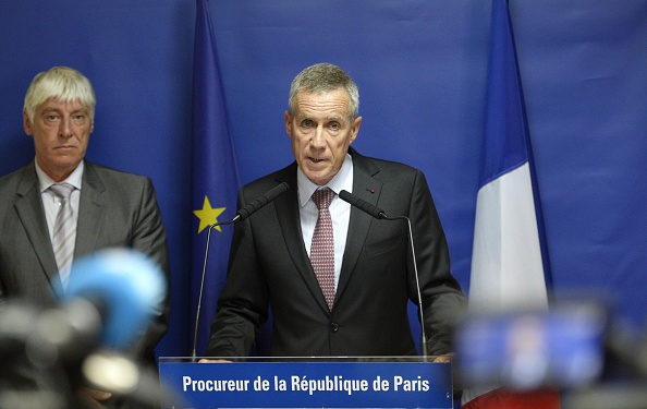 Paris chief prosecutor Francois Molins (R) delivers a speech on August 25, 2015 in Paris during a press conference concerning Ayoub El-Khazzani, the suspect in August 21's Thalys train attack, has been brought before a judge after four days in custody. The 25-year-old Moroccan opened fire on a Thalys train travelling from Amsterdam to Paris, injuring two people before being tackled by several passengers including off-duty American servicemen. On August 25, Paris chief prosecutor Francois Molins affirmed that investigators found El-Khazzani with a "bottle containing 50cl of gasoline" and 270 rounds of ammunition. 
