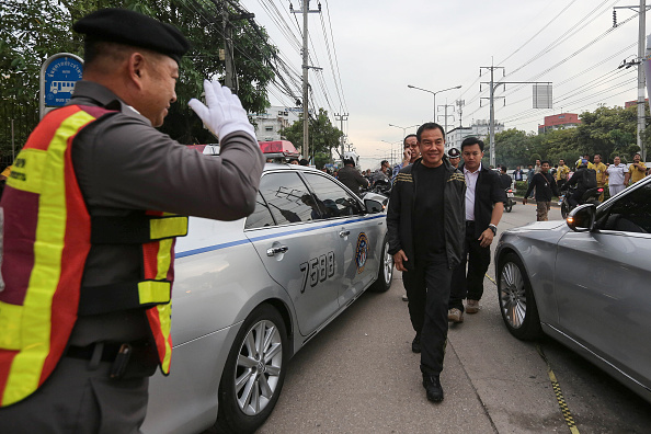 Somyot Poompanmoung, Lieutenant General of the Thai police, center, leaves the building where a suspect in the August 17 Bangkok shrine bombing was detained, in Nong Chok, North West of Bangkok, Thailand, on Saturday, Aug. 29, 2015. Thai police arrested a foreign man in connection with a deadly explosion in central Bangkok almost two weeks ago after discovering bomb-making materials during a search of an apartment in the capital on Saturday.