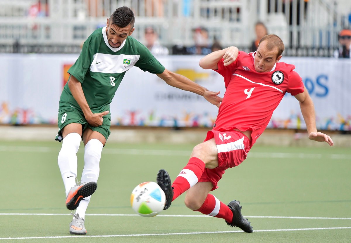 Canada defender John Phillips (4) blocks a shot from Brazil forward Evandro De Oliveira Gomes (8) during first half Football-7 at the Parapan American Games in Toronto on Wednesday, August 12, 2015. 