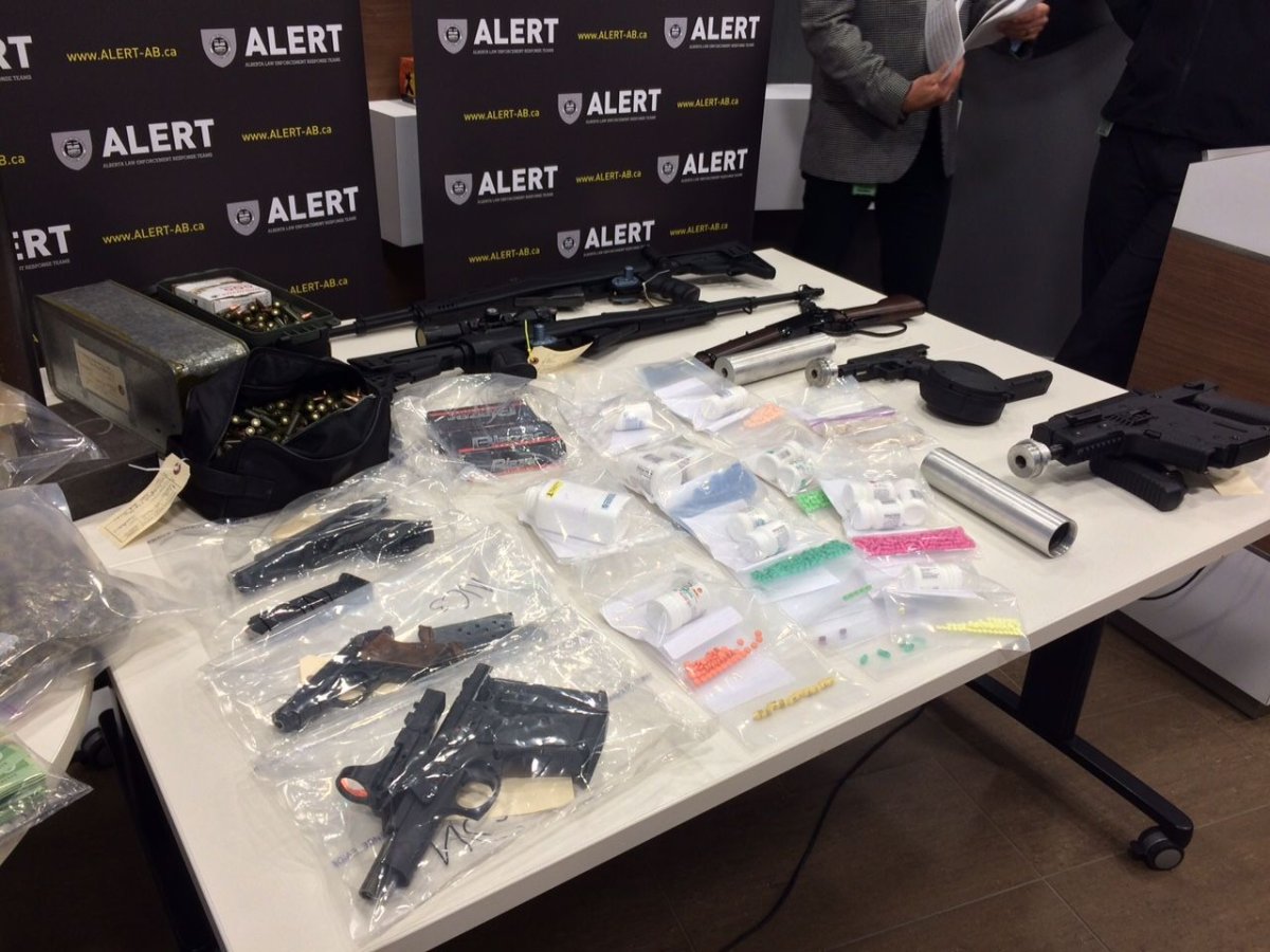 Four people were charged after an Alberta Law Enforcement Response Teams raid in north Edmonton uncovered eight high-powered firearms and more than $100,000 worth of drugs. 