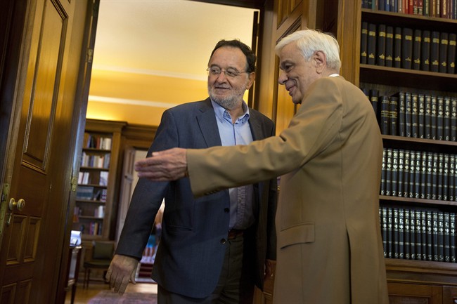 Former Energy Minister and head a party called Popular Unity , Panagiotis Lafazanis, left , is welcomed by Greek President Prokopis Pavlopoulos, in Athens, Monday Aug. 24, 2015.