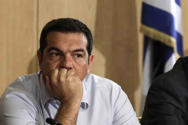 Greek Prime Minister Alexis Tsipras listens during his visit at the transport ministry in Athens, Wednesday, Aug. 12, 2015. 