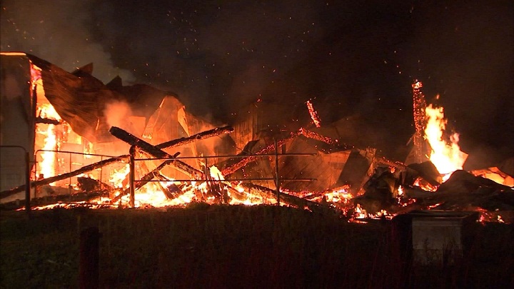 A fire tears through a barn in Saint-Ambroise-de-Kildare early Sunday morning. Aug. 16, 2015.