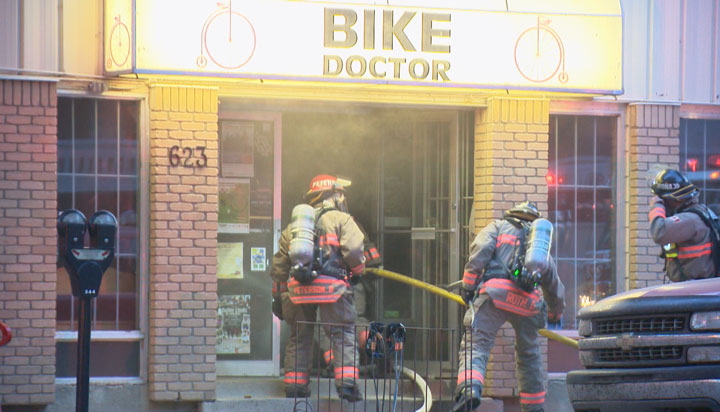 Saskatoon fire crews work to save Main Street bike shop from flames on Friday.