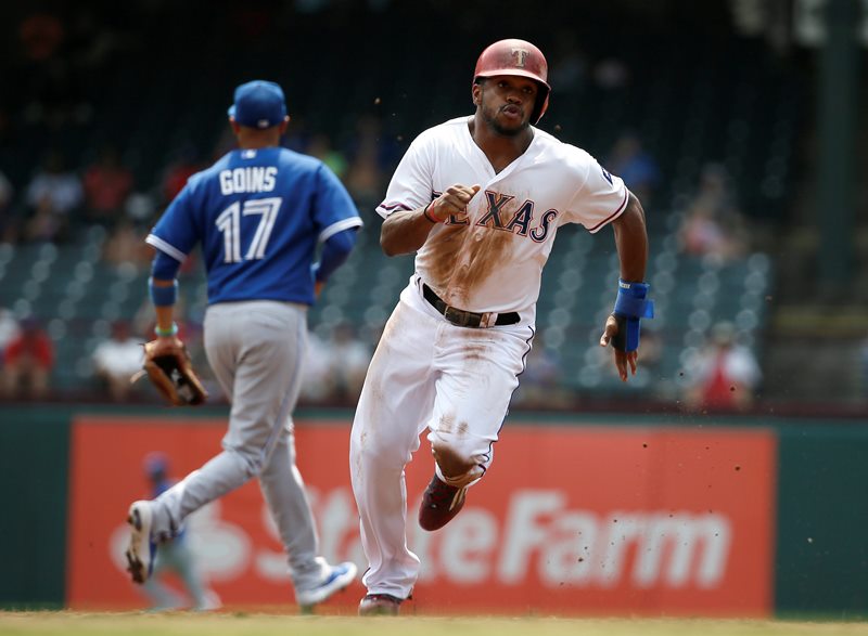 Texas Rangers' Delino DeShields advances to third on a single by Texas Rangers' Adrian Beltre in the first inning of a baseball game Thursday, Aug. 27, 2015, in Arlington, Texas. 