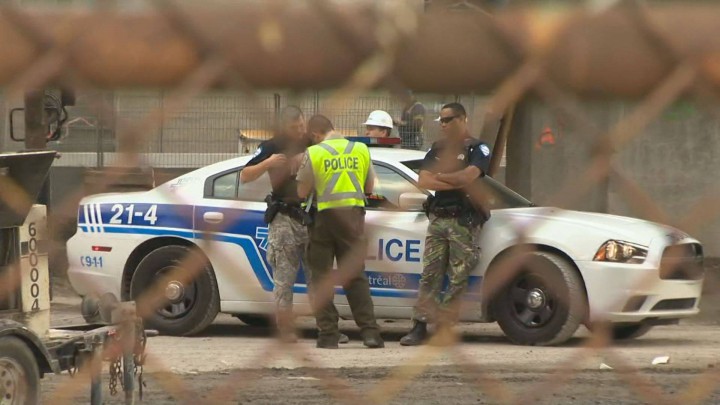 Police on the scene after a worker falls off the Bonaventure Autoroute, Thursday, August 20, 2015.