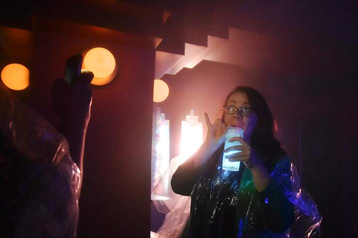 A customer poses for a photograph outside  the cocktail room called the “Cloud’’ by its inventors, which uses a humidifier to pump a gin and tonic vapour into an enclosed space.