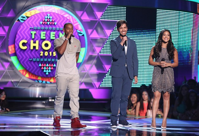 Hosts Ludacris, from left, Josh Peck and Gina Rodriguez speak onstage at the Teen Choice Awards at the Galen Center on Sunday, Aug. 16, 2015, in Los Angeles. (Photo by Matt Sayles/Invision/AP).
