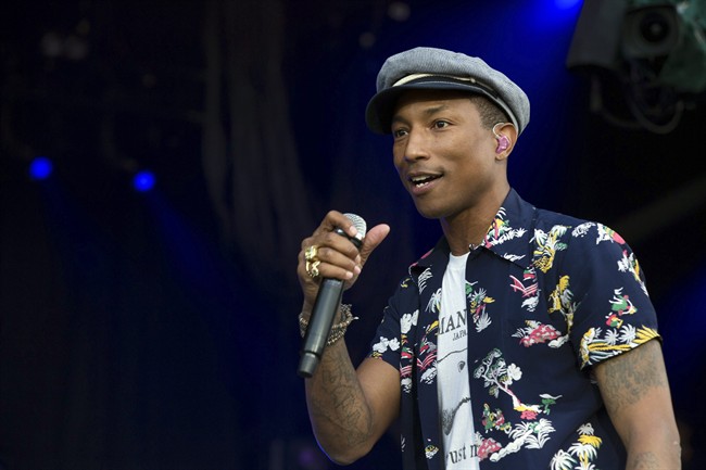 In this June 27, 2015 file photo, singer Pharrell Williams performs on the Pyramid Stage at Glastonbury music festival at Worthy Farm, Glastonbury, England. Williams, One Direction and Florence   The Machine are going to appear at the Apple Music Festival next month. Apple announced Tuesday, Aug. 18, 2015, that the musicians will be among the headliners at the 10-night festival at London’s Roundhouse that begins Sept. 19. 