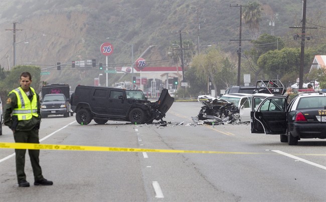 FILE - In this Saturday, Feb. 7, 2015 file photo, Los Angeles County Sheriff's deputy guards the scene of a collision involving three vehicles in Malibu, Calif.