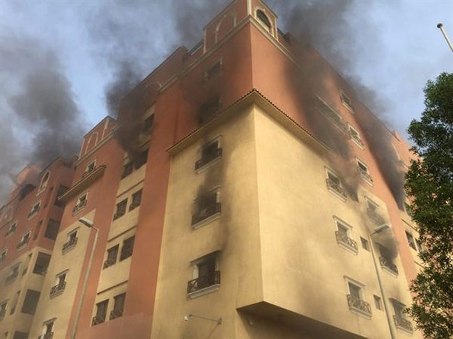 In this image released by the Saudi Interior Ministry’s General Directorate of Civil Defense, smoke billows from a fire at a residential complex used by state oil giant Saudi Aramco in Khobar, Saudi Arabia, Sunday, Aug. 30, 2015. 